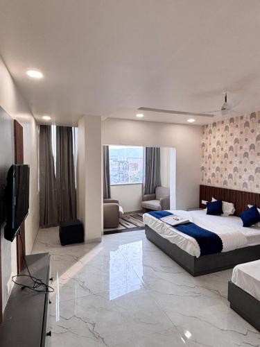 a bedroom with a bed and a flat screen tv at Hotel Golden Heights in Ajmer