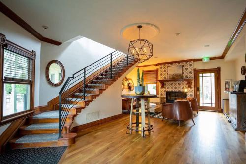 a living room with a staircase and a dining room at Pinky's Palace - Curtis Park Club - RiNo in Denver