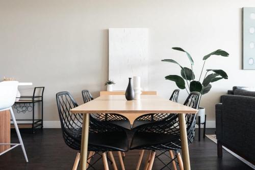 a dining room with a wooden table and chairs at New Spacious Modern Loft - Center of LoHi in Denver