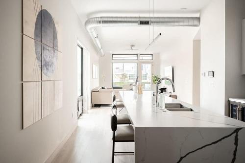 a kitchen with a large white island in a room at Contemporary Condo - Grill - Balcony - Tesoro in Denver
