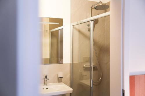 a bathroom with a sink and a shower at Locanda del Persico in Morbio Inferiore