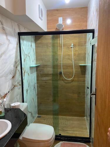 a bathroom with a shower with a toilet and a sink at Estalagem O Italiano in Lumiar
