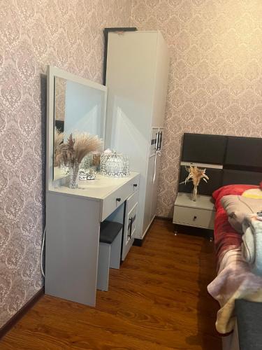 a bedroom with a white dresser and a mirror at Kakuti village in Natskhavatevi