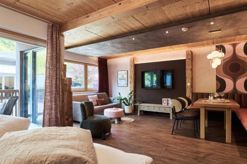 a bedroom with a bed and a living room at Apart Marienberg in Lermoos