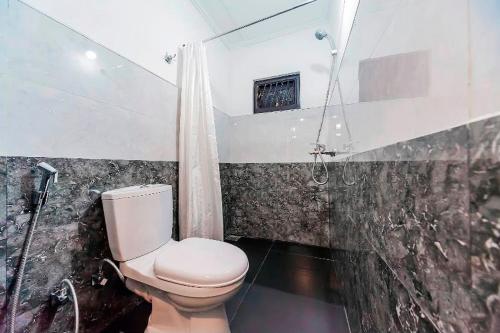 a bathroom with a toilet and a shower at Cloud Inn Kandy Homestay - Near temple tooth in Kandy