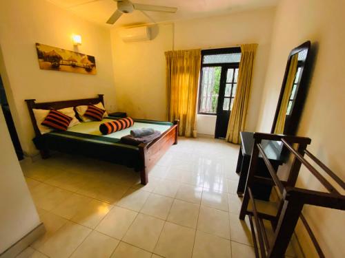 a living room with a bed and a window at Cloud Inn Kandy Homestay - Near temple tooth in Kandy