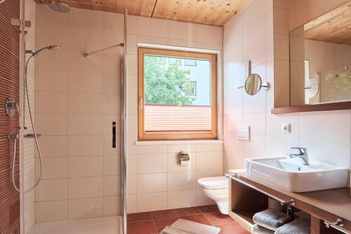 a bathroom with a sink toilet and a shower at Apart Marienberg in Lermoos