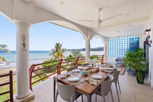 a dining room with a table and a view of the ocean at Beachfront Penthouse with Panoramic Ocean Views in Playa Flamingo