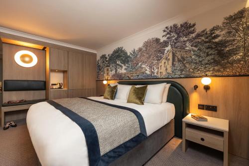 a hotel room with a bed and a painting on the wall at Menlo Park Hotel in Galway