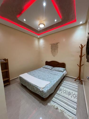 a bedroom with a bed and a red light on the ceiling at Quiet Aourire Hideway in Aourir