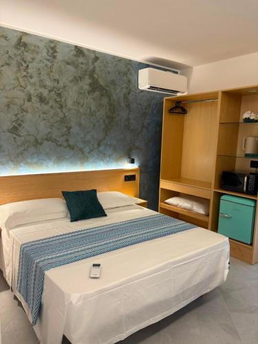 a bedroom with a large bed and a wall at Relax nel Centro Storico in San Nicola Arcella