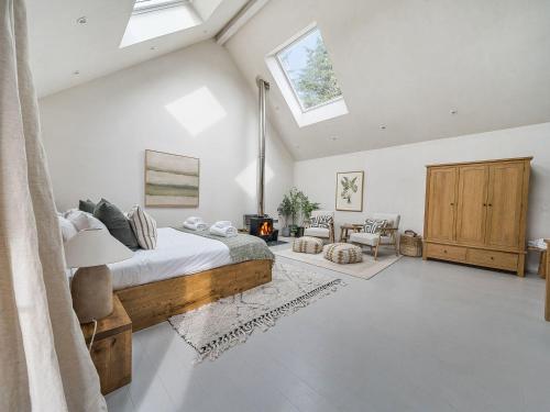 a bedroom with a bed and a skylight at Grove Cottage in Kington