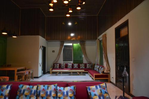 a living room with a couch and a table at Brookside Pines in Murree