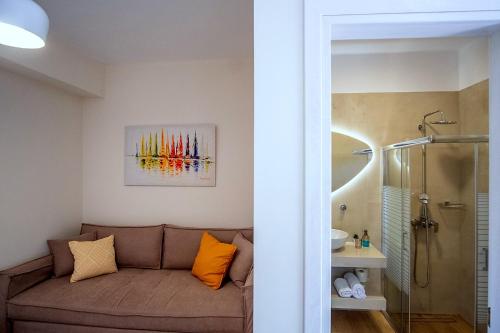 a living room with a couch and a shower at Rousis Studios in Parga