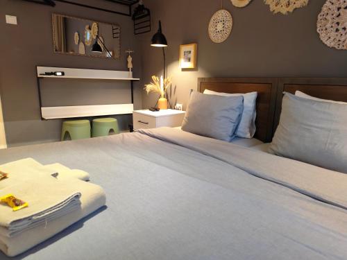 a bedroom with a large white bed with blue pillows at Mila Apartment in Skopje