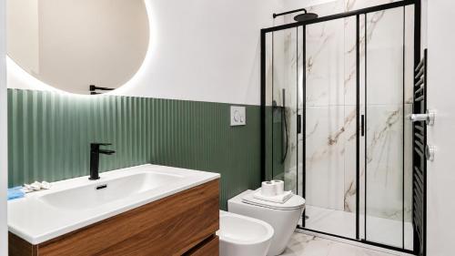 a bathroom with a sink and a toilet and a shower at Elegantis Luce di Trastevere Apartment with Terrace - Comfort in Most Charming District in Rome