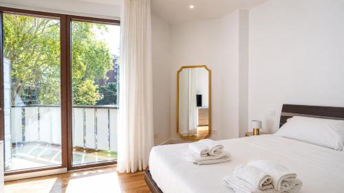 a bedroom with a bed and a large window at Elegantis Luce di Trastevere Apartment with Terrace - Comfort in Most Charming District in Rome