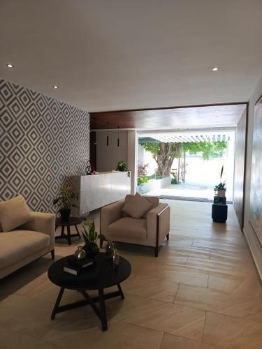 a living room with two couches and a table at Departamento en Monné in Mérida