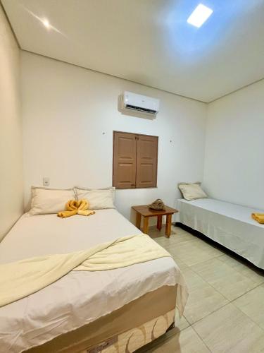 a bedroom with two beds in a room at Vila da Andrea in Barreirinhas