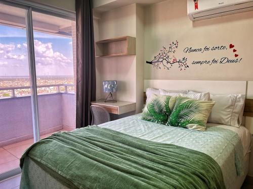 a bedroom with a bed with a green comforter at 2802 Unique · Studio Unique c/ garagem in Belém