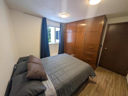 a bedroom with a bed and a dresser at Casa Terraza Zacatlan in Zacatlán