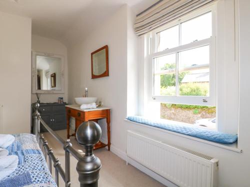 a bedroom with a window and a bed and a sink at Sunnyside in Matlock