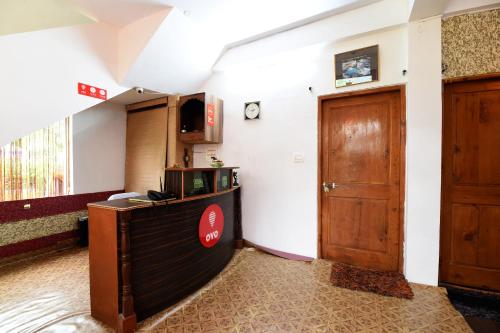 a room with a door and a counter in a room at Hotel O by OYO Manali Meadows Home Stay in Manāli