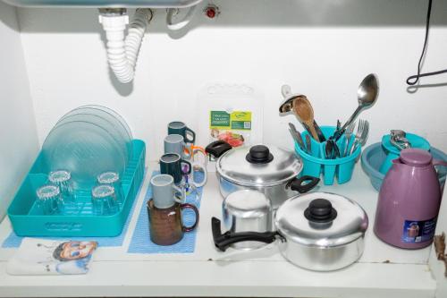 a kitchen counter with dishes and utensils on it at Di Villa Búzios in Búzios