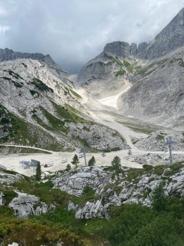 a view of a mountain with a dirt road at Apartma Confine in Rateče