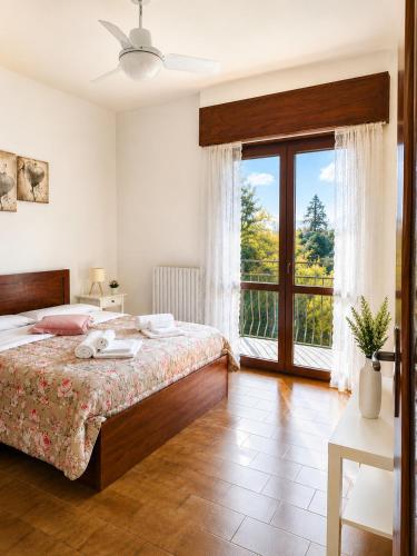 a bedroom with a bed and a large window at Little house Lezzeno in Lezzeno