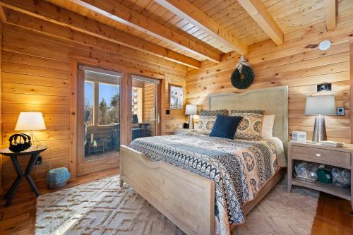 a bedroom with a bed in a log cabin at Pleasant View in Island Falls