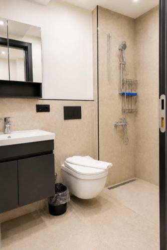 a bathroom with a toilet and a sink and a shower at Bodrum has apart otel in Bodrum City