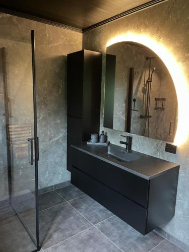 a bathroom with a sink and a mirror at Trudvang in Tänndalen