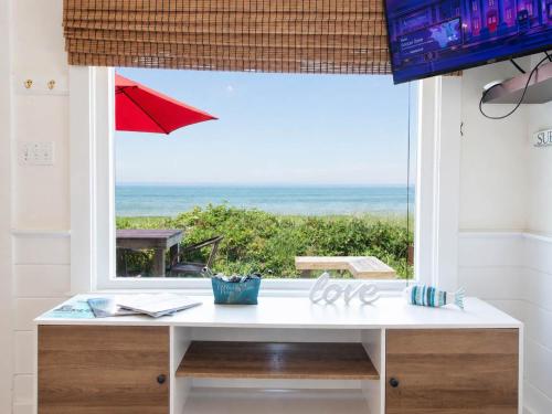 a white desk with a view of the ocean at Beachfront on Skaket Water Views in Orleans