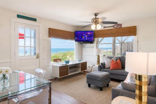 a living room with a view of the ocean at Beachfront on Skaket Water Views in Orleans