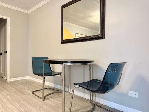 a table and chairs in a room with a mirror at Downtown Condo! Private Balcony! PT10F in Atlanta