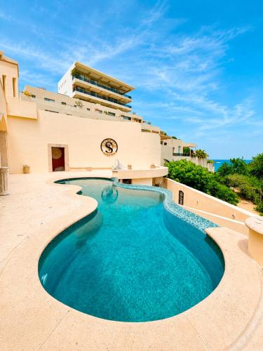 a swimming pool in the middle of a patio with a building at The Sanctuary Boutique Hotel in Tangolunda