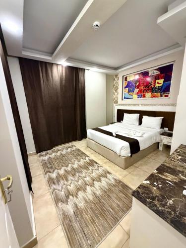 a bedroom with a bed and a rug at La Boutique Residence in Hurghada