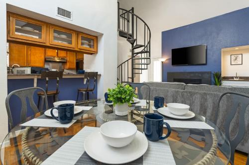 a dining room with a table and a couch at Spacious Austin Loft 4BR Sleeps 12 in Austin