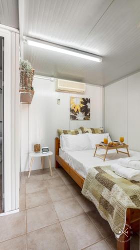 a bedroom with a large bed and a table at Casa fig Crete in Chania