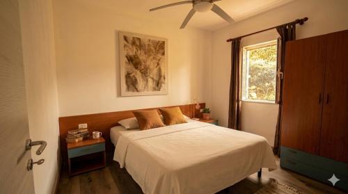 a bedroom with a bed and a window at De Sio Country Village in Peschici
