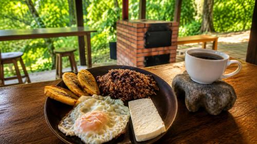 a plate of eggs and bread and a cup of coffee at Parque Indigo Nature Lodge, Rincón de la Vieja in Liberia