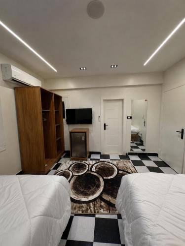 a hotel room with two beds and a tv at GREAT PYRAMIDS View lodge in Cairo