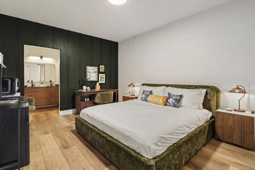 a bedroom with a large bed and a television at The Warren Hotel in Bridgman