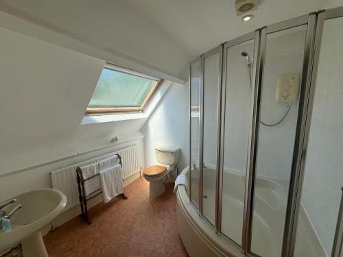 a bathroom with a shower and a sink and a toilet at The Briary in Sheffield