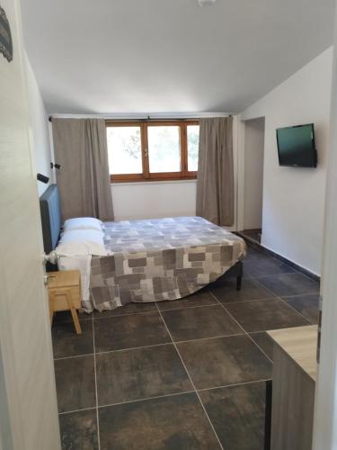 a bedroom with a bed in a room with a window at Country House Villa Marezi in Cupra Marittima