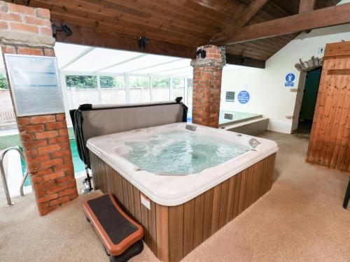 a large jacuzzi tub in a room at Owl in Pickering