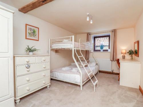 a bedroom with a bunk bed and a dresser at Owl in Pickering