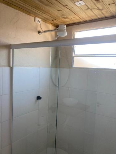 a shower with a glass door in a bathroom at Paraitinga Glamping in São Luiz do Paraitinga