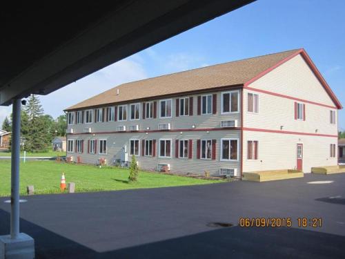 a large white and red building with a red at Driftwood Motel in Niagara Falls